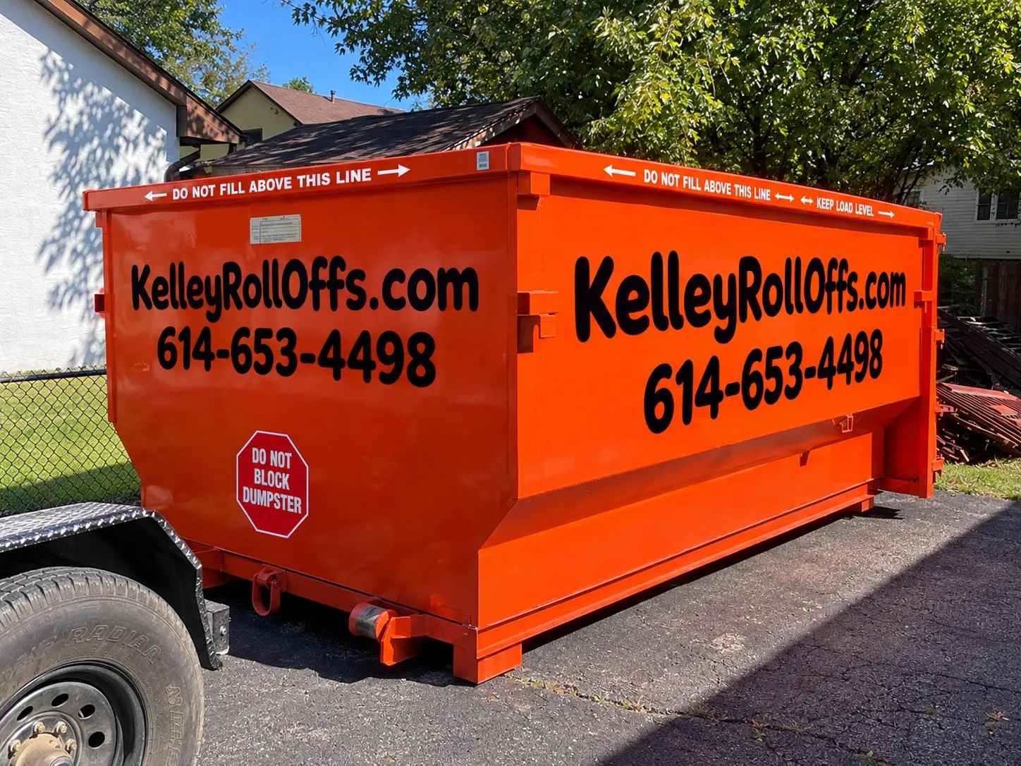 Kelley Roll-Offs dumpster beside a home